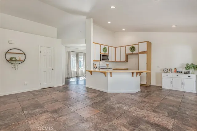 a kitchen with white cabinets appliances and a sink