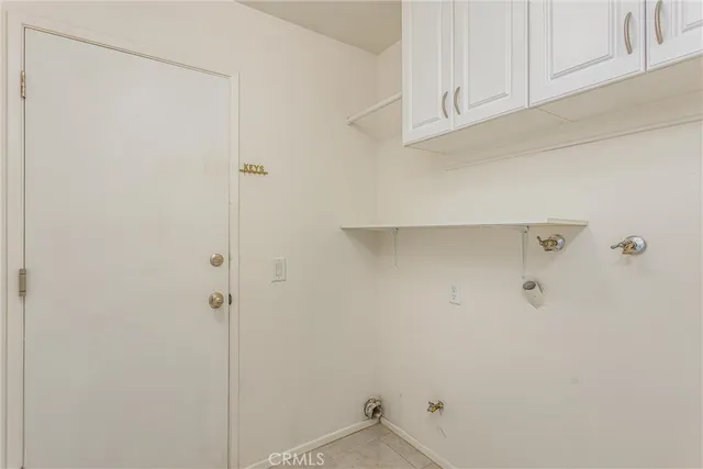 an empty room with a chandelier fan