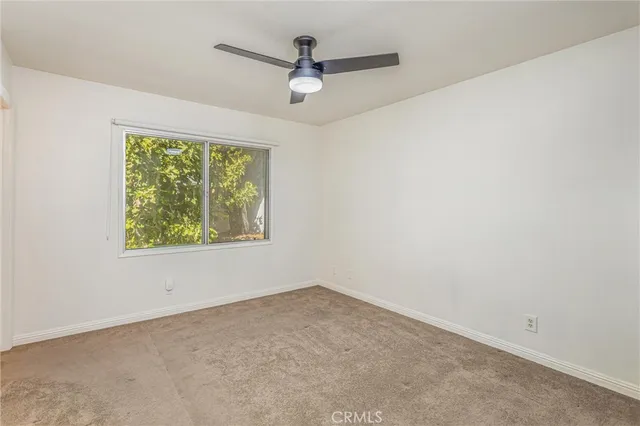 a bathroom with a granite countertop sink toilet and a mirror