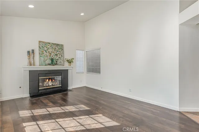 a living room with a fireplace and a wooden floor