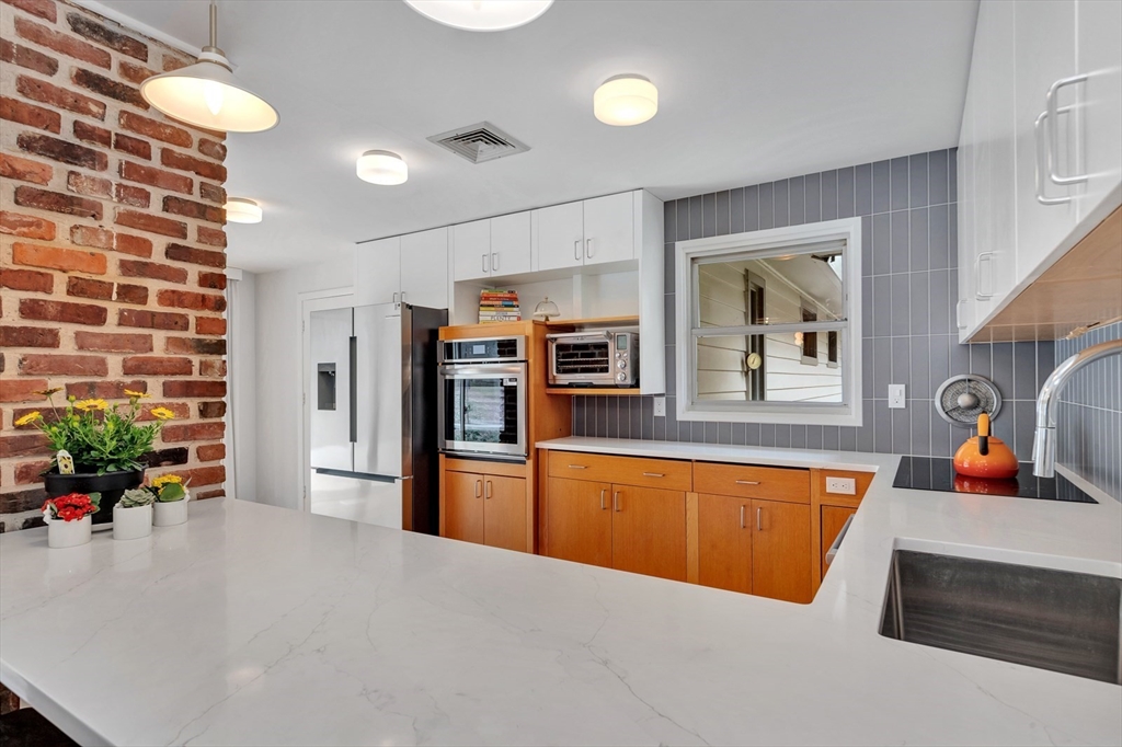 85 The Valley Road Concord, MA 01742 - Photo 10 of 38 a kitchen with stainless steel appliances granite countertop a refrigerator and a sink