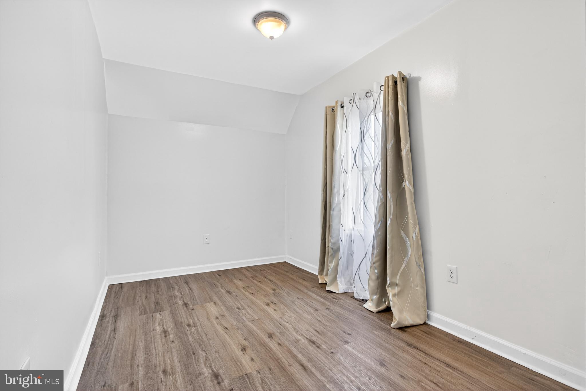 1118 Sterling Avenue Linwood, PA 19061 - Photo 22 of 38 an empty room with wooden floor and a window
