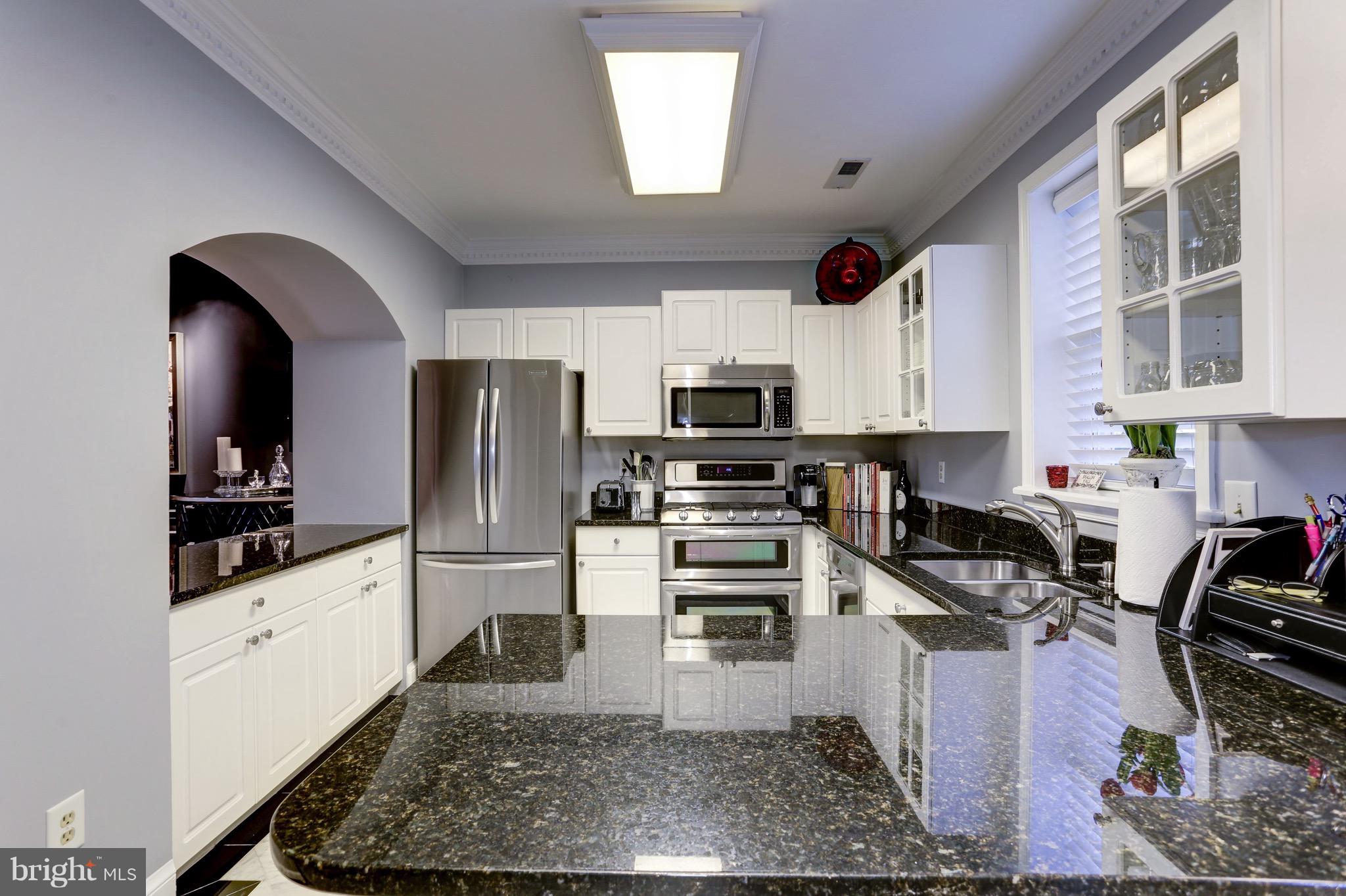 224 9th Street Southeast Washington, DC 20003 - Photo 11 of 29 a kitchen with granite countertop a stove a sink and a refrigerator