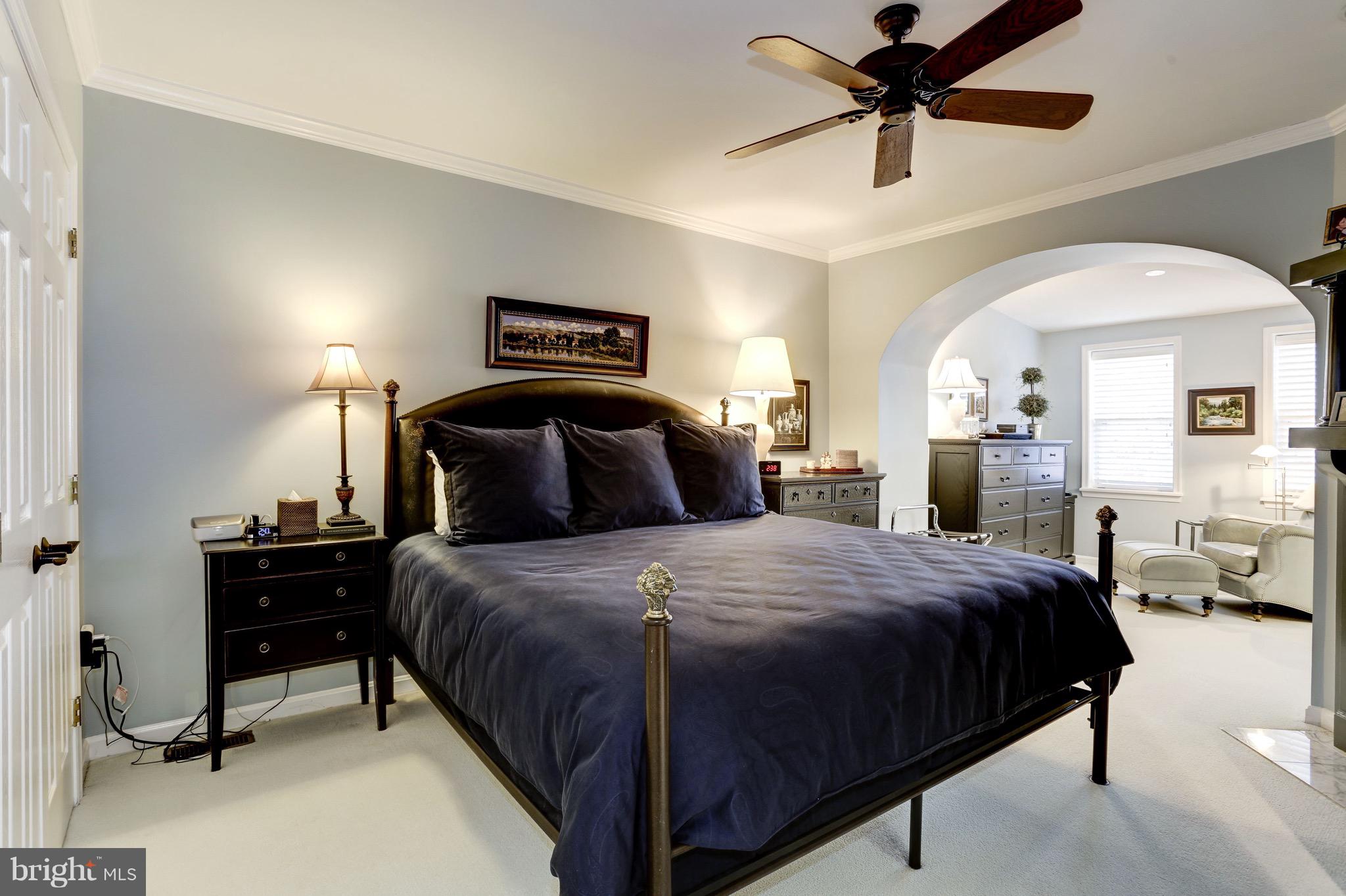 224 9th Street Southeast Washington, DC 20003 - Photo 13 of 29 a bedroom with a bed and a chandelier