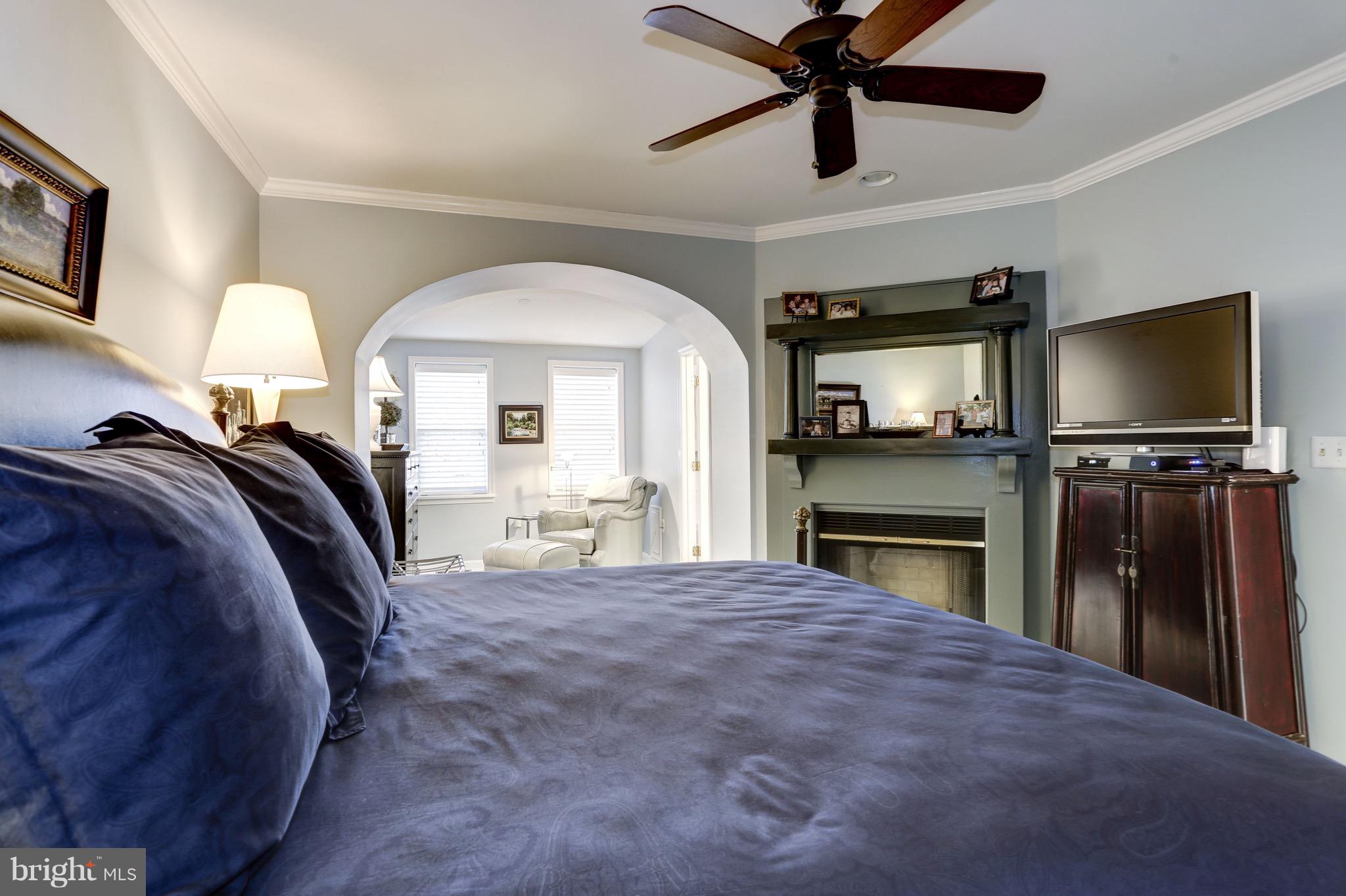 224 9th Street Southeast Washington, DC 20003 - Photo 14 of 29 a view of a livingroom with a fireplace a ceiling fan and a kitchen view