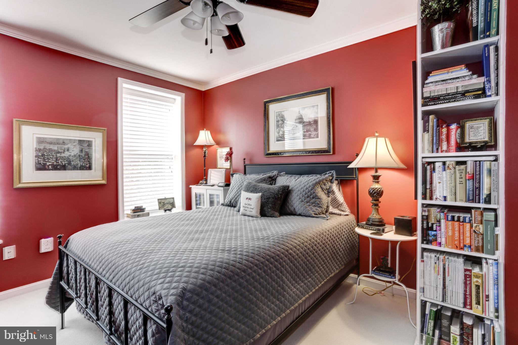 224 9th Street Southeast Washington, DC 20003 - Photo 19 of 29 a bedroom with a bed a book shelf and a window