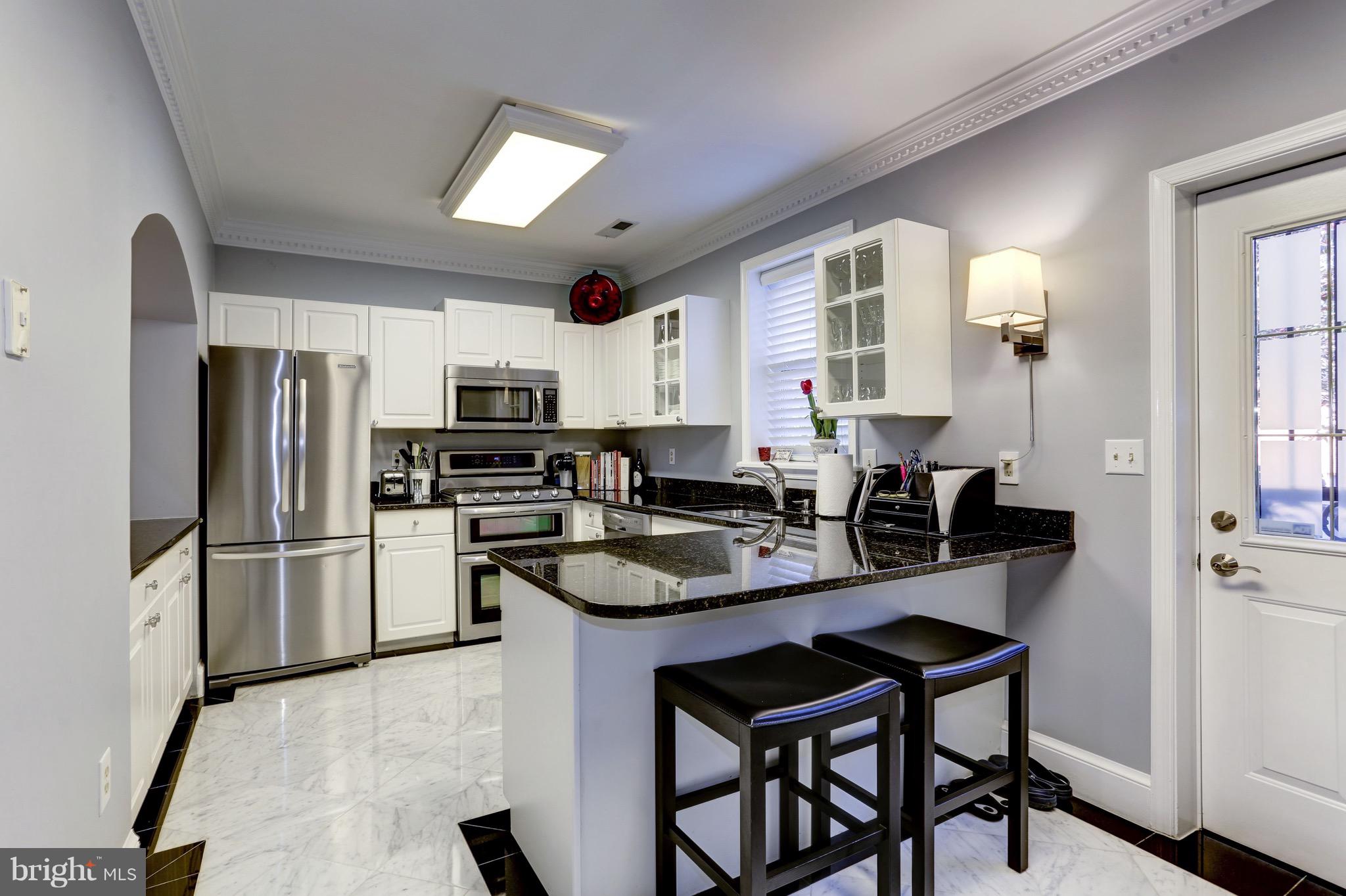 224 9th Street Southeast Washington, DC 20003 - Photo 9 of 29 a kitchen with a refrigerator a stove a sink and dishwasher with wooden floor