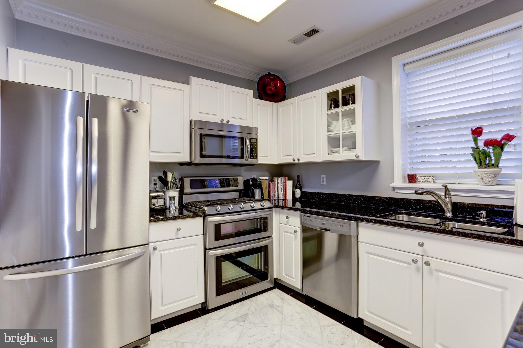 224 9th Street Southeast Washington, DC 20003 - Photo 10 of 29 a kitchen with stainless steel appliances granite countertop a refrigerator sink and stove