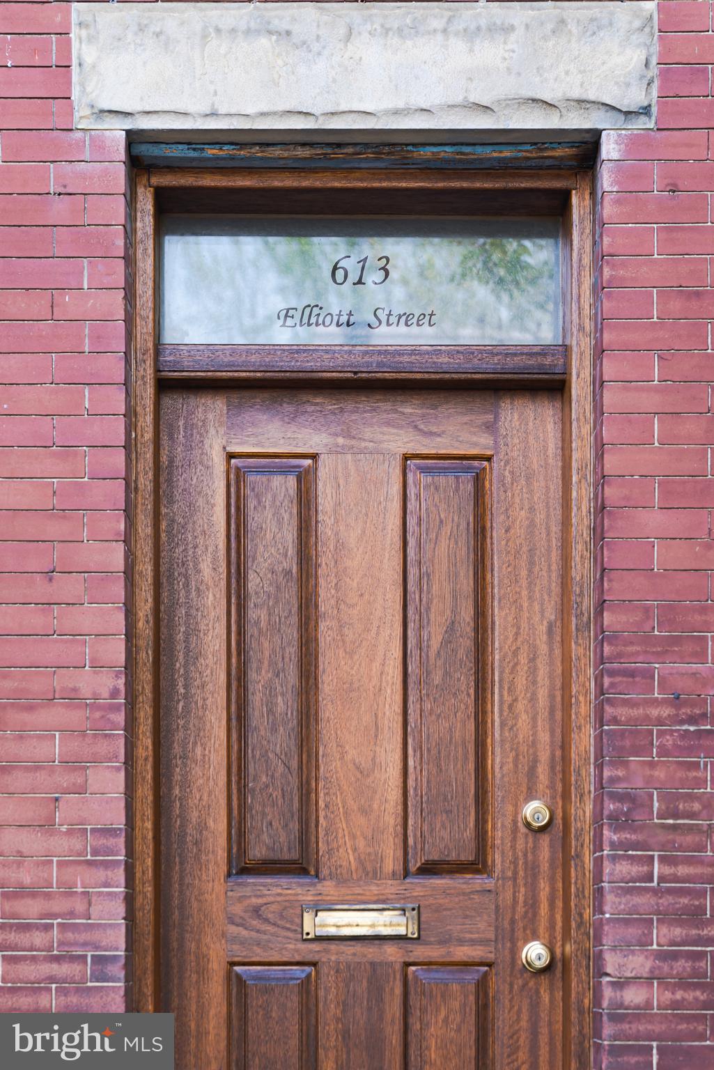 a view of door with wooden cabinets