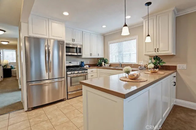 a kitchen with kitchen island a sink appliances and cabinets