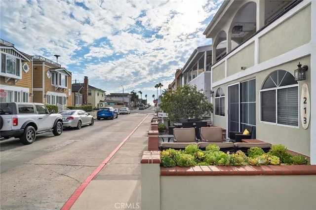 a view of a building with a yard and car parked