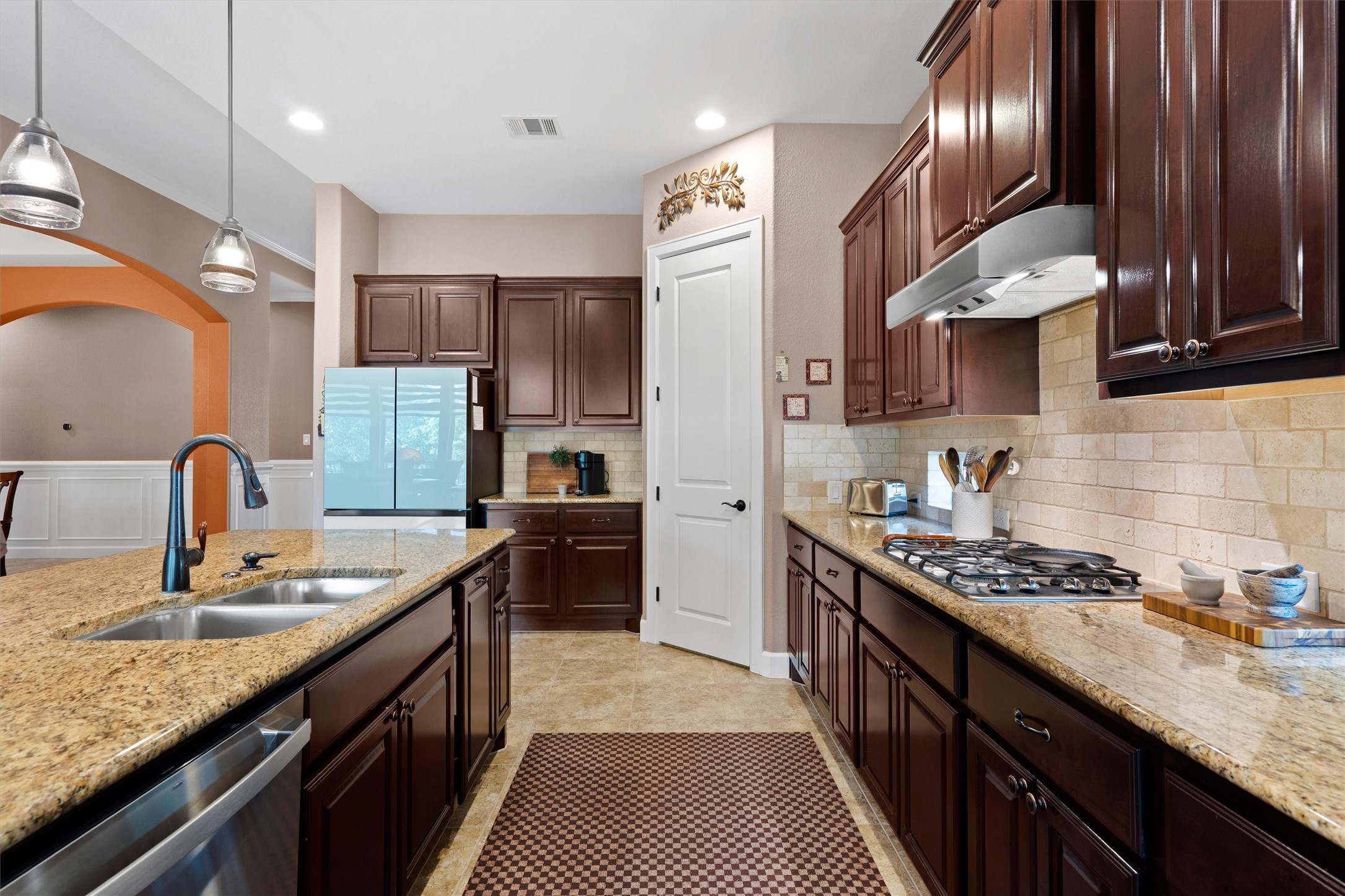 4005 Haight Street Round Rock, TX 78681 - Photo 17 of 40 a kitchen with stainless steel appliances granite countertop sink stove refrigerator and cabinets