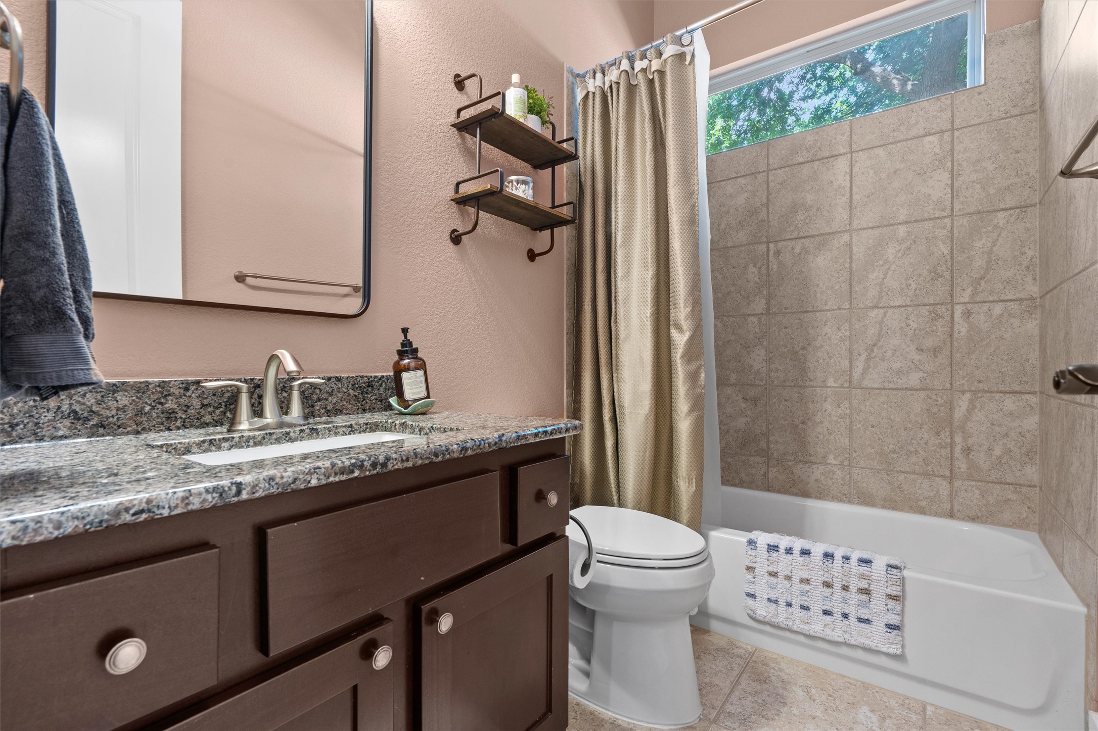 4005 Haight Street Round Rock, TX 78681 - Photo 30 of 40 a bathroom with a granite countertop sink a toilet and shower
