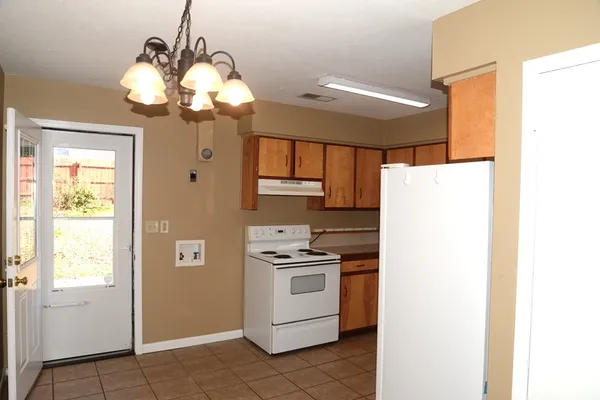 a kitchen with a refrigerator a stove top oven a sink and dishwasher