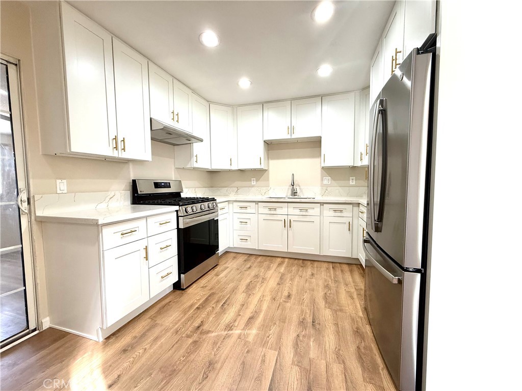 930 West Franklin Avenue Ridgecrest, CA 93555 - Photo 14 of 31 a kitchen with white cabinets and white appliances