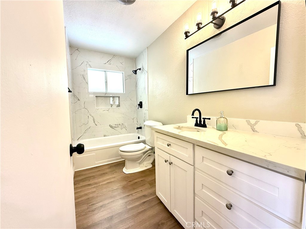 930 West Franklin Avenue Ridgecrest, CA 93555 - Photo 16 of 31 a bathroom with a granite countertop toilet sink and mirror