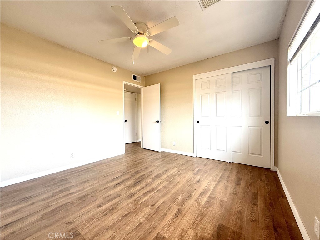 930 West Franklin Avenue Ridgecrest, CA 93555 - Photo 17 of 31 wooden floor in an empty room with a window