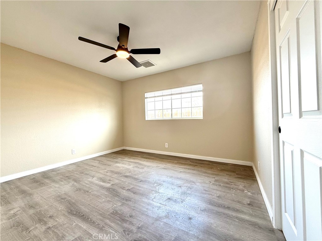 930 West Franklin Avenue Ridgecrest, CA 93555 - Photo 18 of 31 a view of empty room with wooden floor and fan