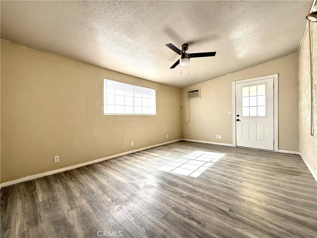930 West Franklin Avenue Ridgecrest, CA 93555 - Photo 21 of 31 a view of empty room with wooden floor and fan