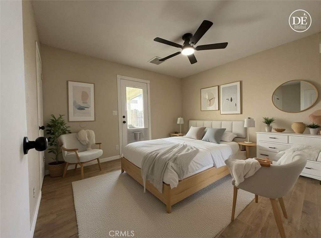 930 West Franklin Avenue Ridgecrest, CA 93555 - Photo 25 of 31 a spacious bedroom with a bed a couch and a chandelier