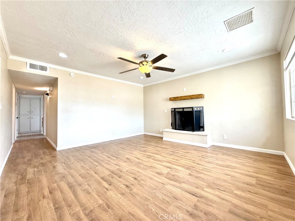 930 West Franklin Avenue Ridgecrest, CA 93555 - Photo 6 of 31 a view of a big room with wooden floor and a ceiling fan