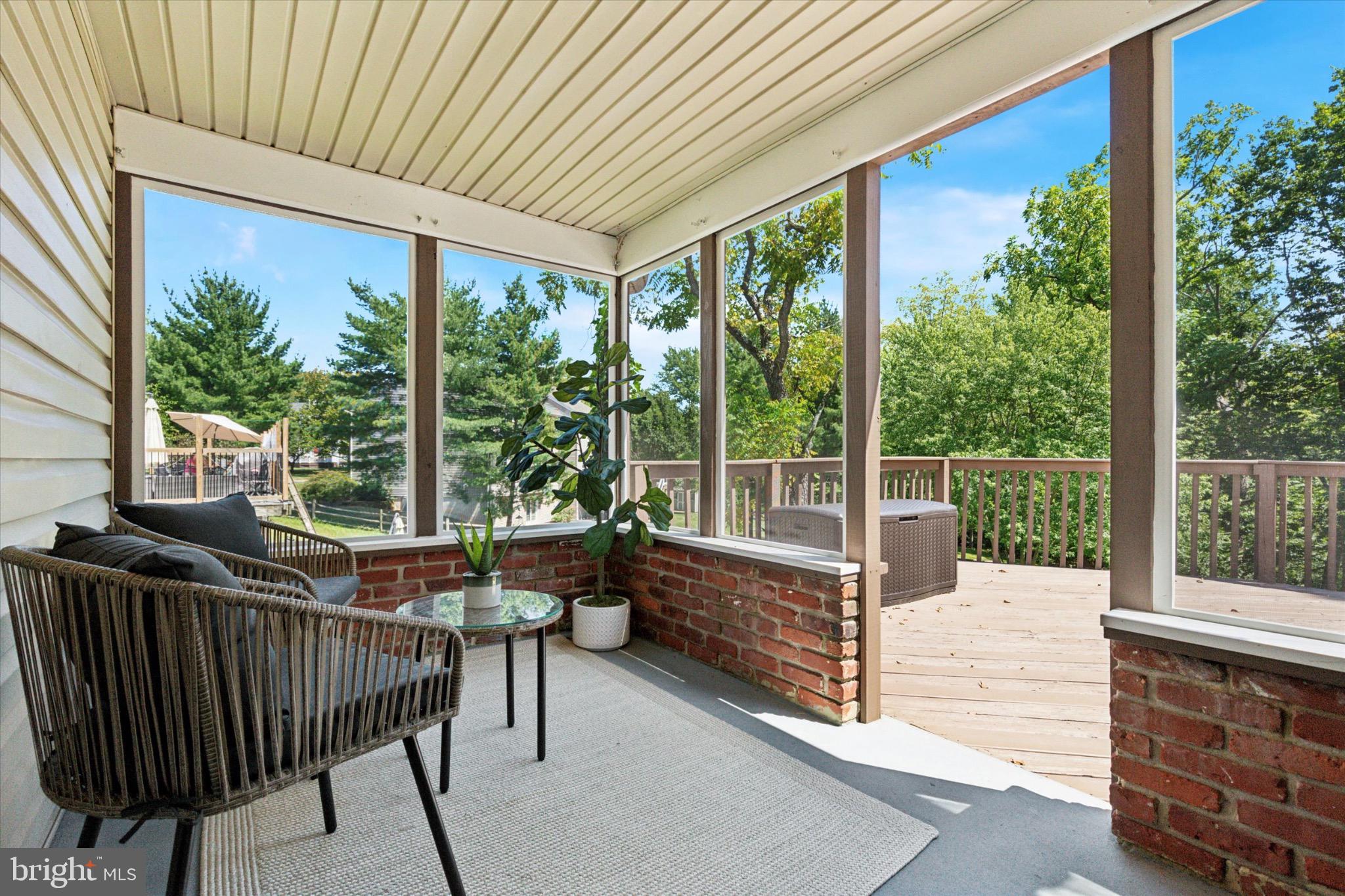 24 Cheyenne Road Royersford, PA 19468 - Photo 16 of 32 Serene sunlit porch with lush greenery views.