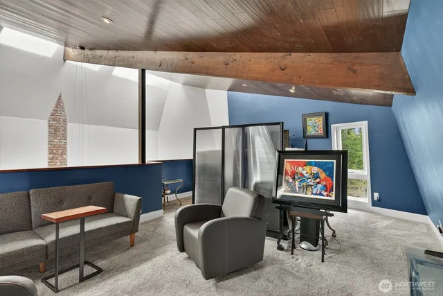 a living room with furniture a rug and a wall painting