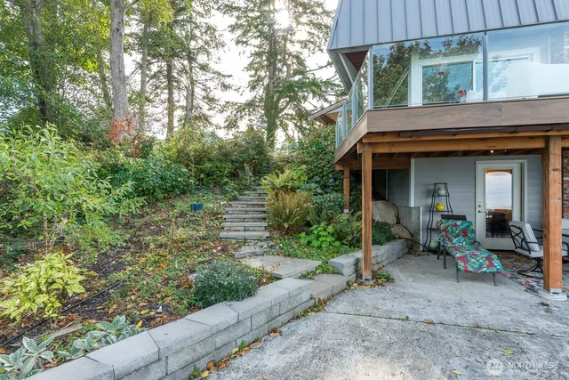 a view of a chair and table in backyard of the house