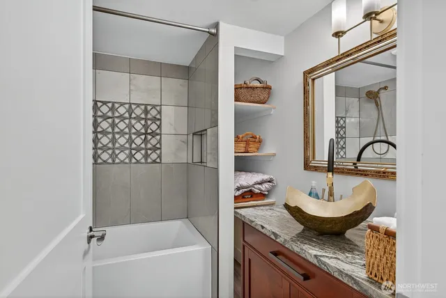 a bathroom with a granite countertop sink and a mirror