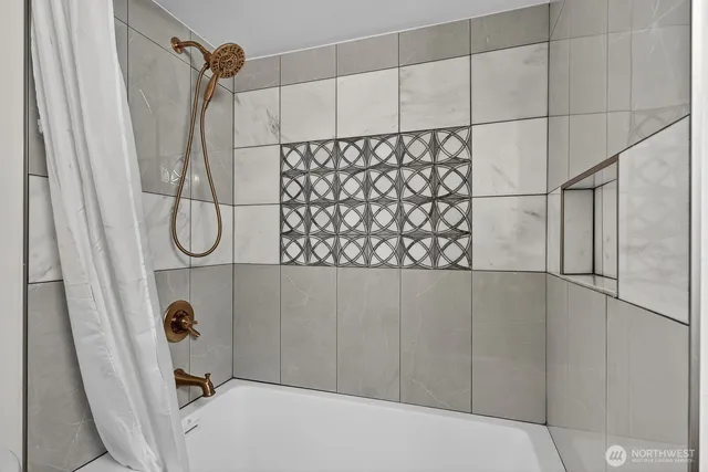 a bathroom with a shower and a shower head