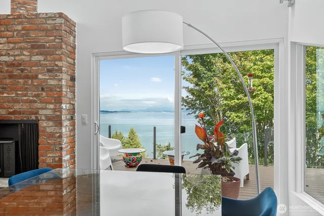 a vase of flowers sitting on a table in front of a window