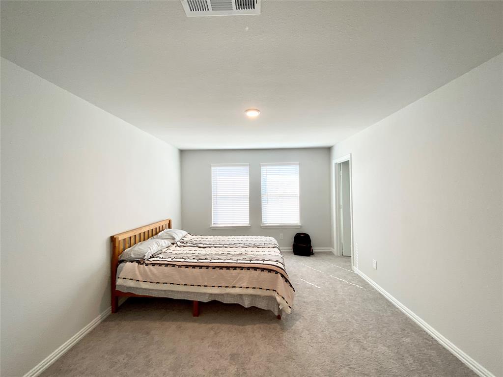 1510 Verbena Lane Garland, TX 75042 - Photo 7 of 10 a bedroom with a bed and a window