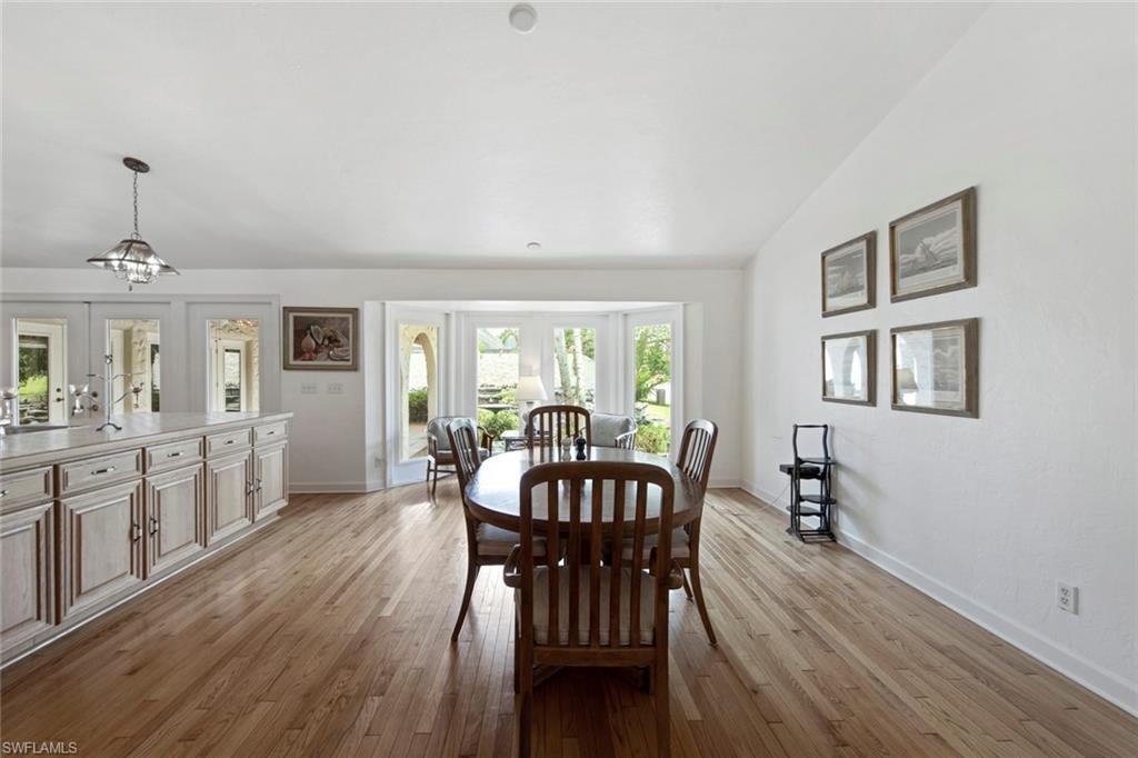 589 Neapolitan Way Naples, FL 34103 - Photo 12 of 27 a view of a dining room with furniture window and wooden floor