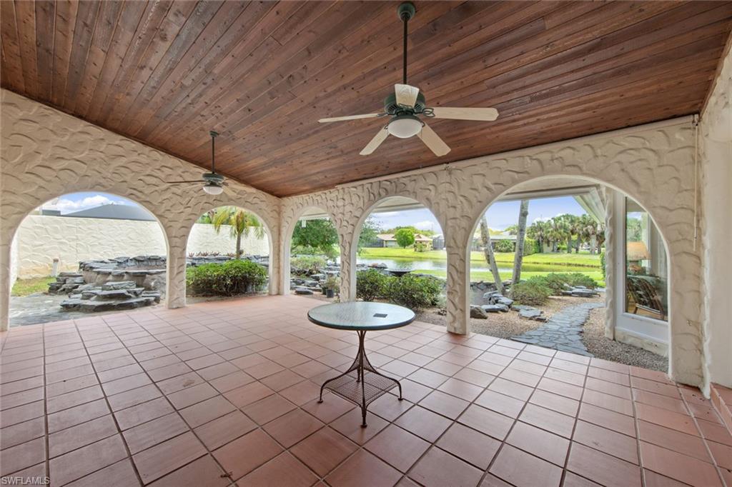 589 Neapolitan Way Naples, FL 34103 - Photo 18 of 27 a view of an entryway with a garden