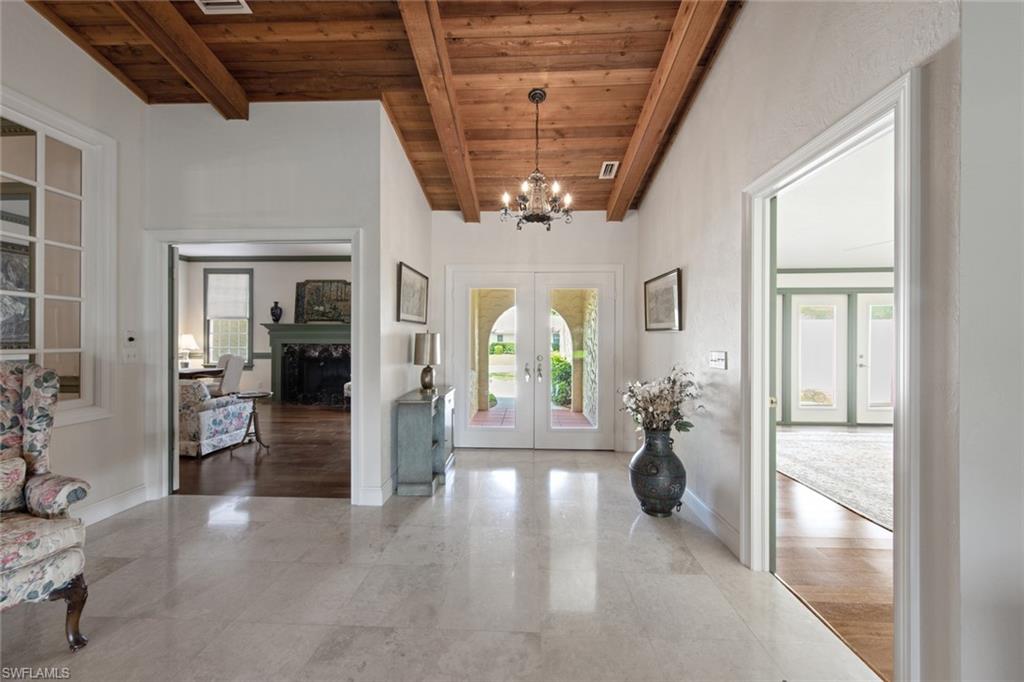 589 Neapolitan Way Naples, FL 34103 - Photo 3 of 27 a view of a livingroom with furniture and windows