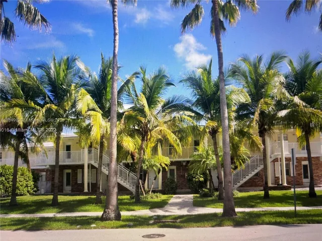 a view of a palm trees in front of a building