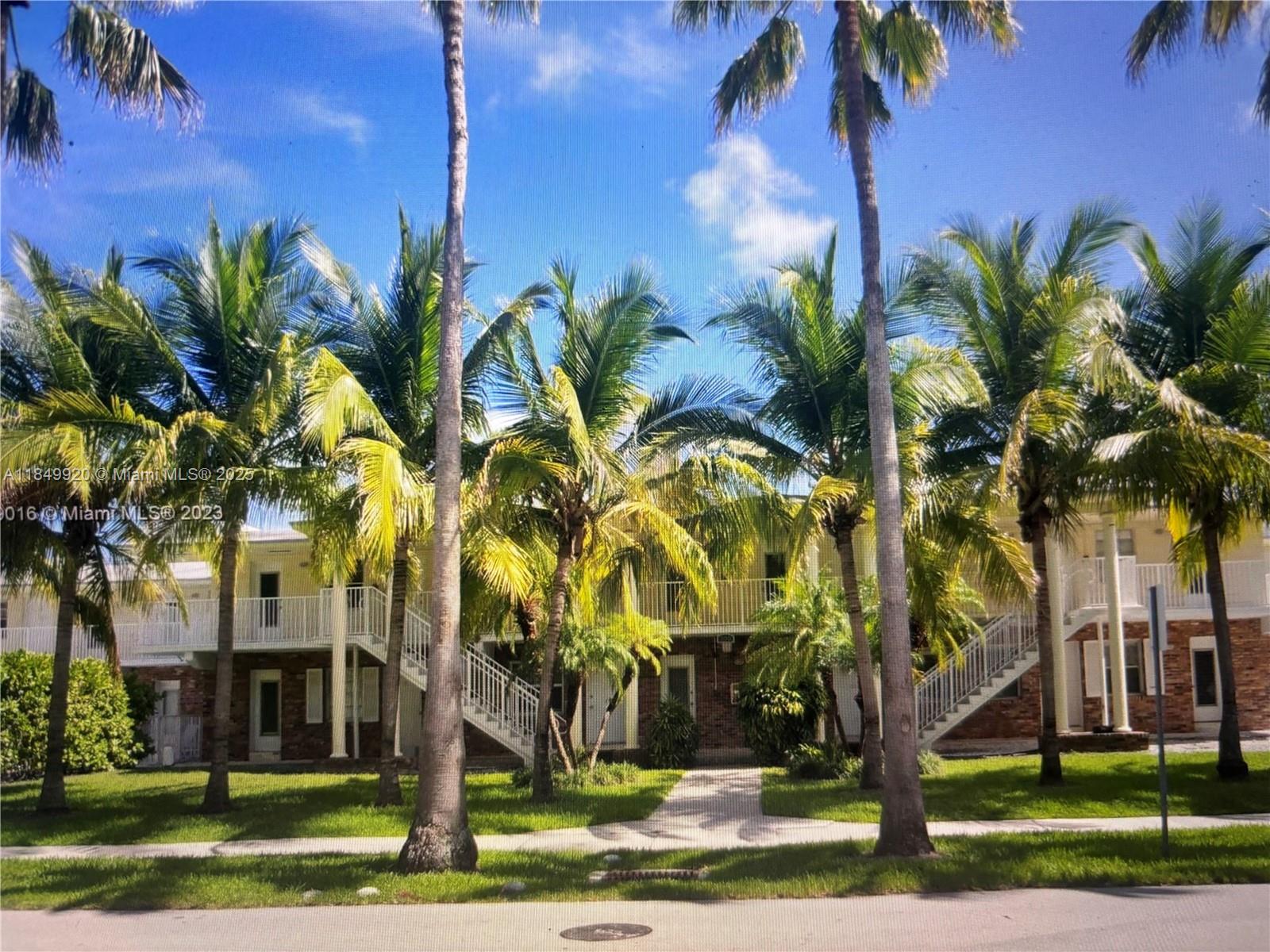 a view of a palm trees in front of a building