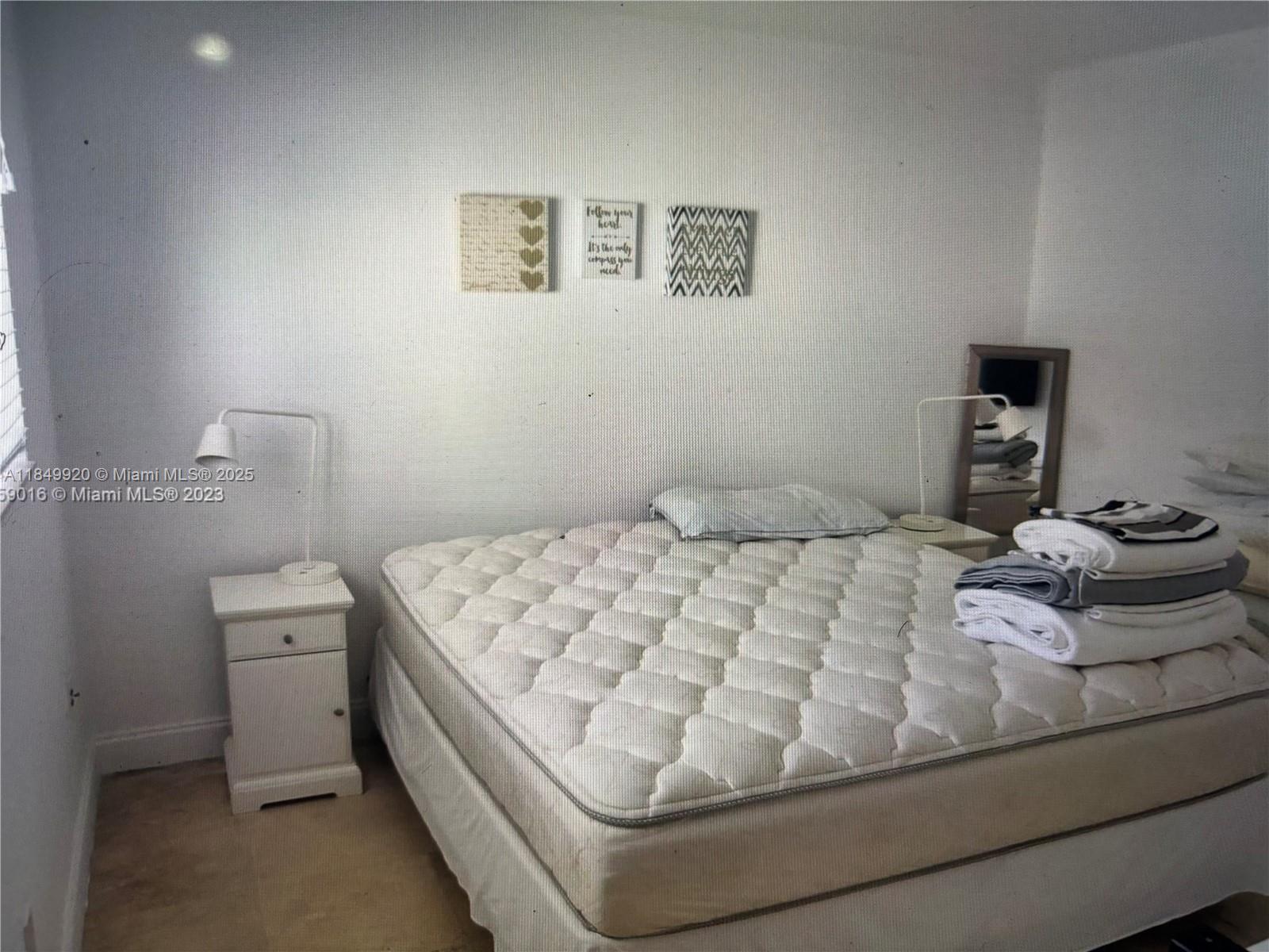 100 Sunrise Drive, Unit 9 Key Biscayne, FL 33149 - Photo 11 of 17 a bedroom with a bed and a lamp on the dresser