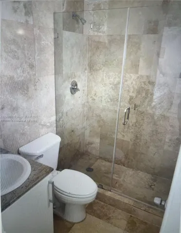 a bathroom with a toilet and a shower