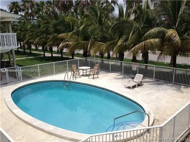 a view of a swimming pool with a patio and a garden