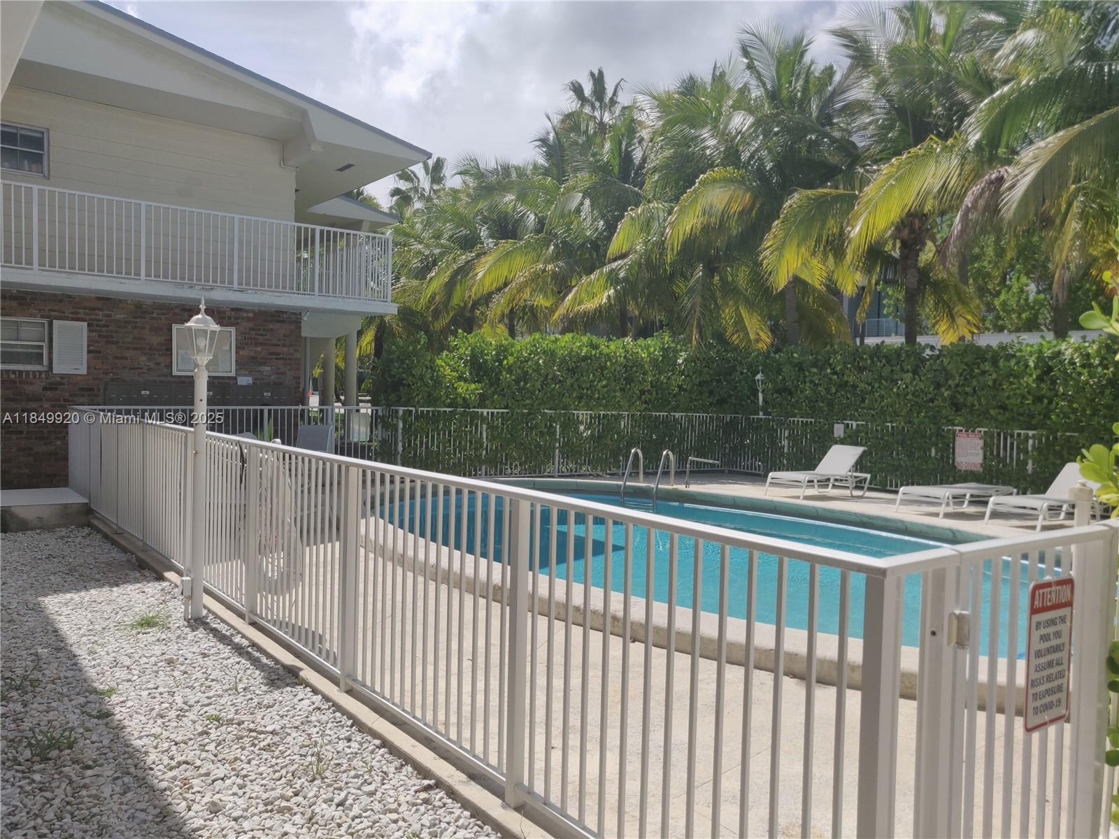 100 Sunrise Drive, Unit 9 Key Biscayne, FL 33149 - Photo 15 of 17 a view of a building from a balcony