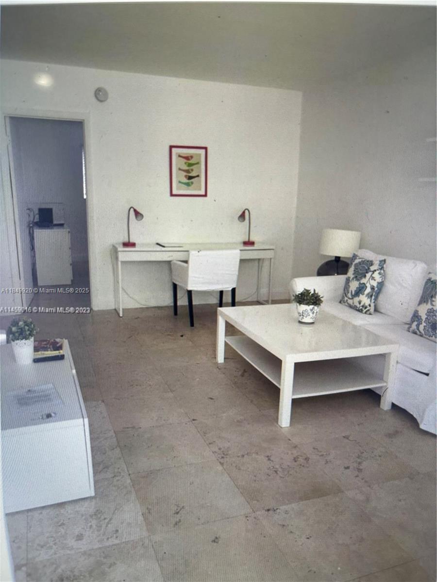 100 Sunrise Drive, Unit 9 Key Biscayne, FL 33149 - Photo 4 of 17 a living room with furniture and a mirror