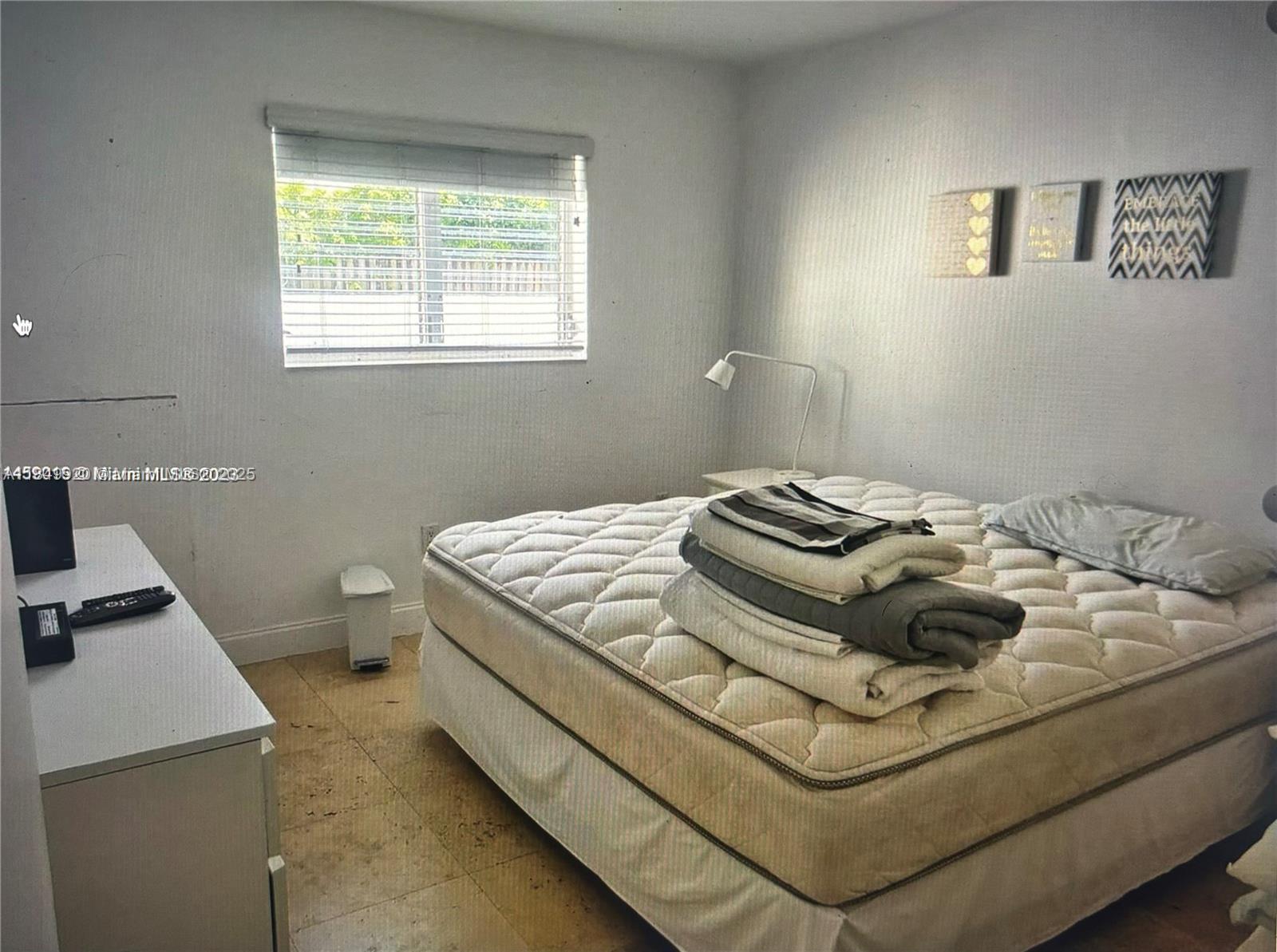 100 Sunrise Drive, Unit 9 Key Biscayne, FL 33149 - Photo 9 of 17 a bedroom with a bed and a window