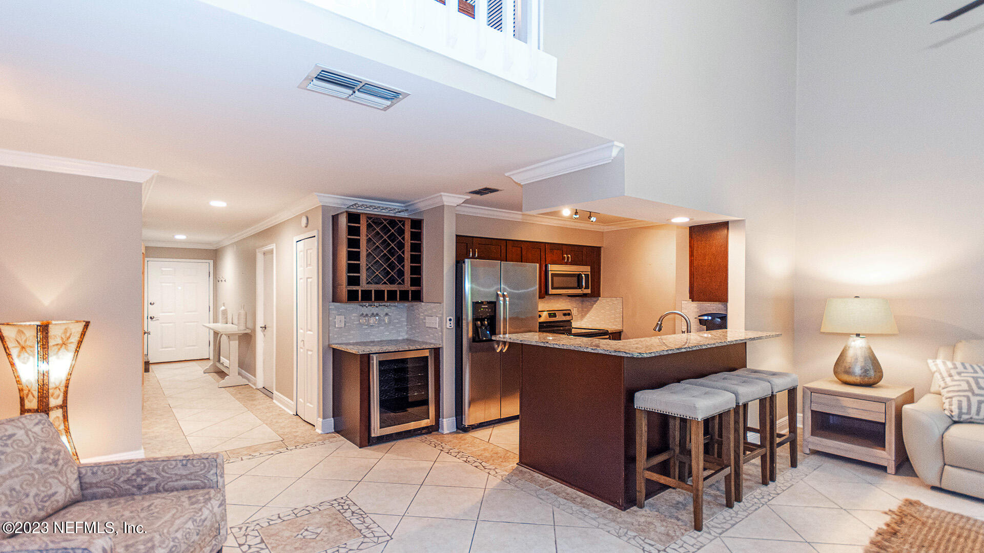 121 Sand Castle Way Neptune Beach, FL 32266 - Photo 12 of 39 a living room with furniture a dining table and kitchen view