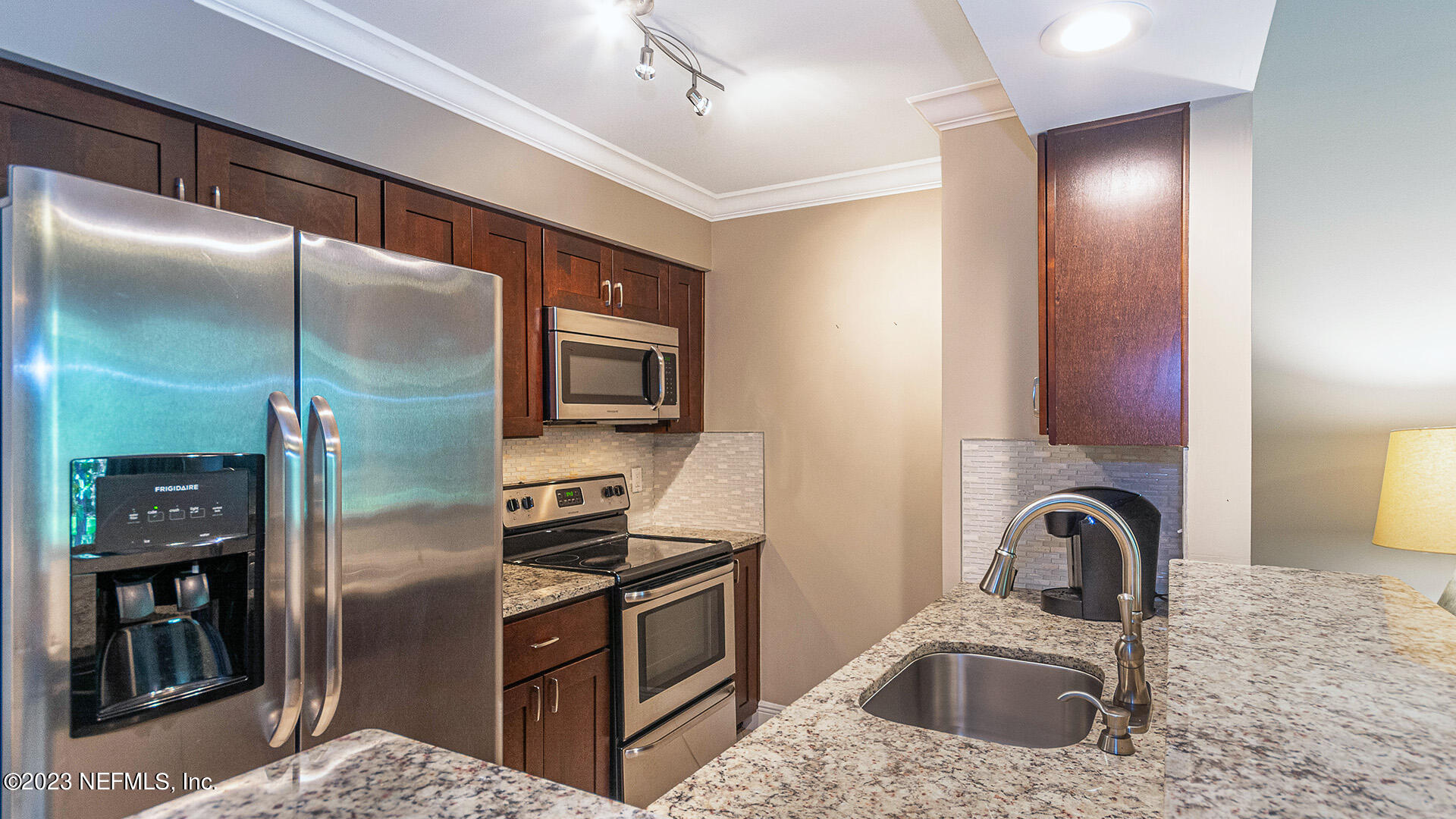 121 Sand Castle Way Neptune Beach, FL 32266 - Photo 13 of 39 a kitchen with stainless steel appliances granite countertop a refrigerator and a sink