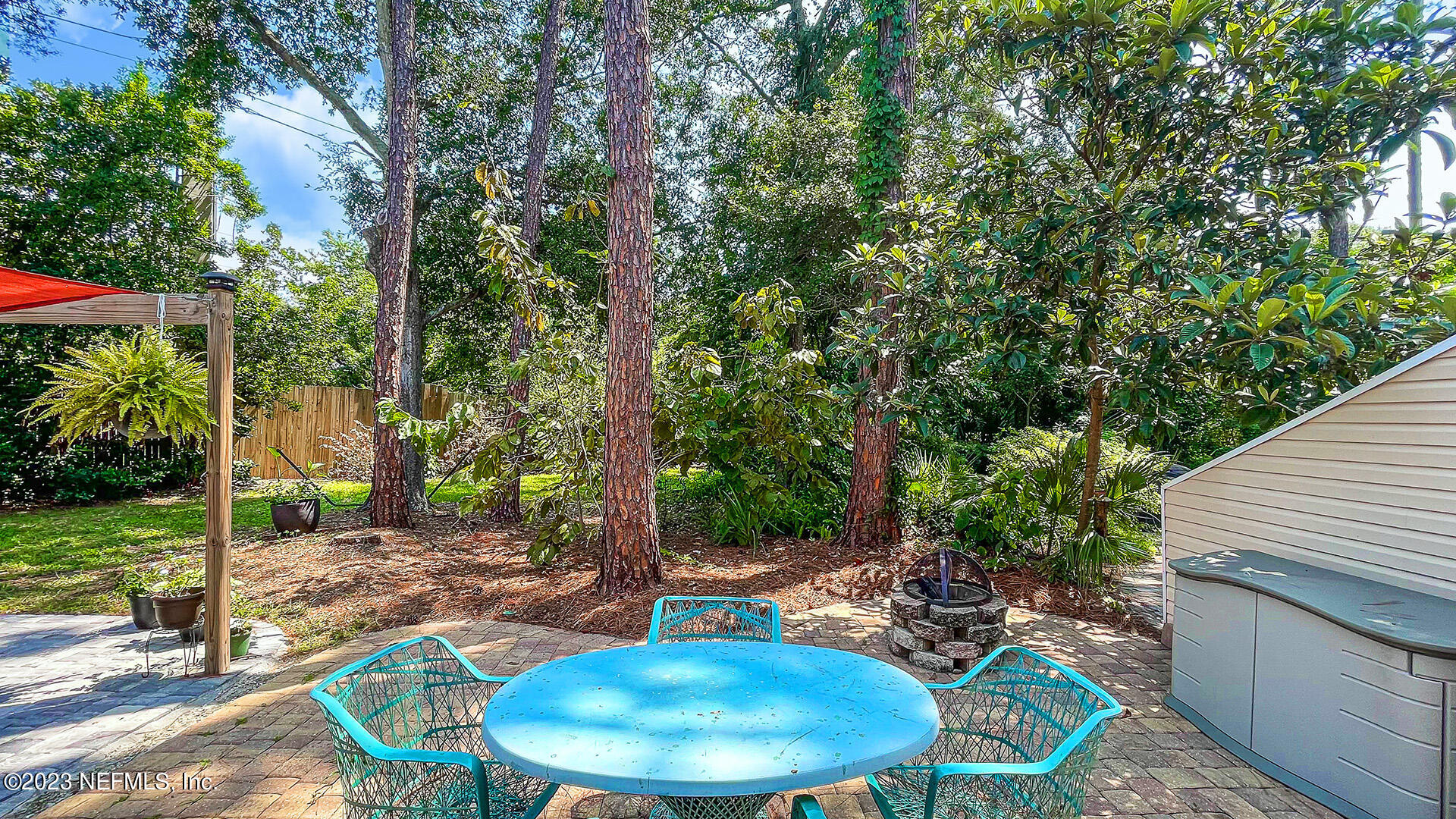 121 Sand Castle Way Neptune Beach, FL 32266 - Photo 31 of 39 a view of a chairs and table in patio with a backyard