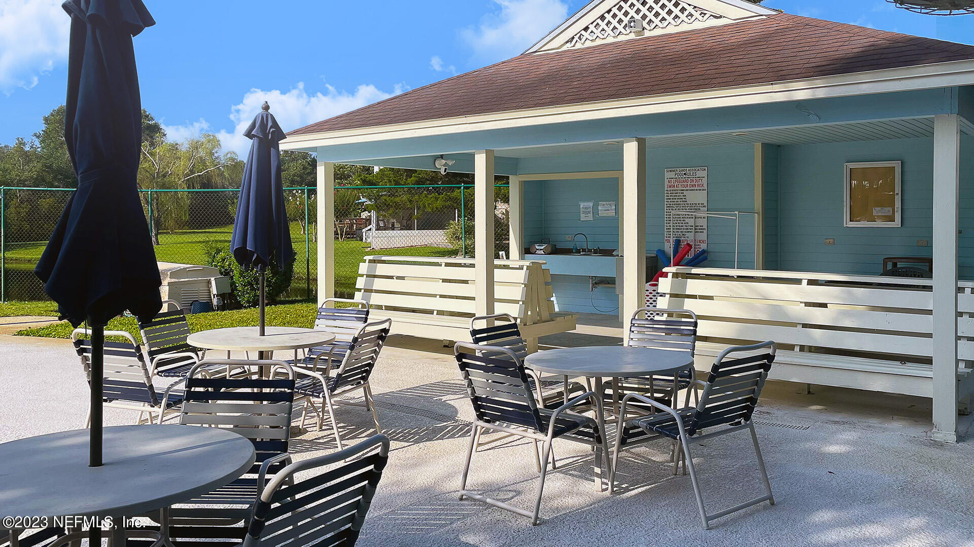 121 Sand Castle Way Neptune Beach, FL 32266 - Photo 36 of 39 a view of a patio with table and chairs floor to ceiling window and wooden floor