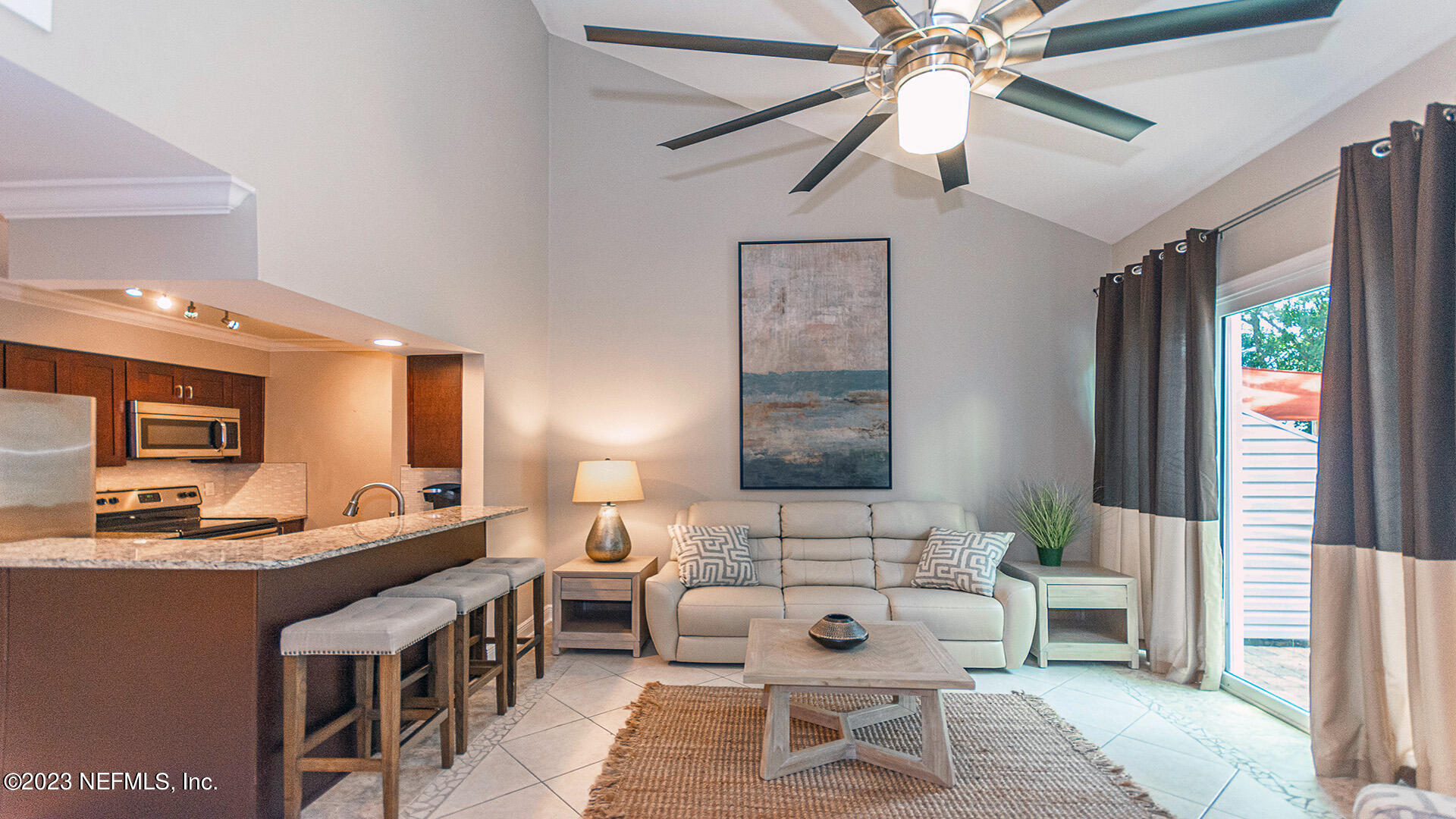 121 Sand Castle Way Neptune Beach, FL 32266 - Photo 6 of 39 a living room with furniture and a large window