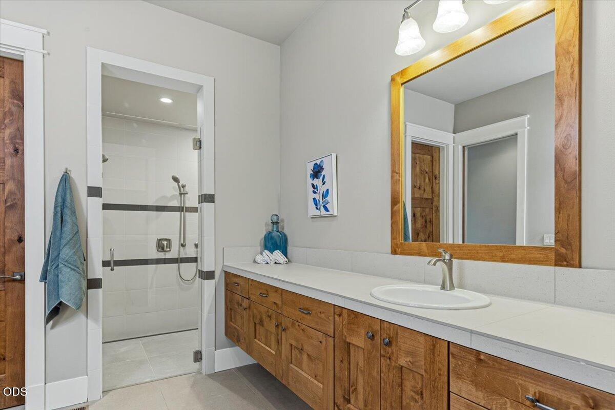 61333 Kindle Rock Loop Bend, OR 97702 - Photo 35 of 53 a bathroom with a double vanity sink and a mirror