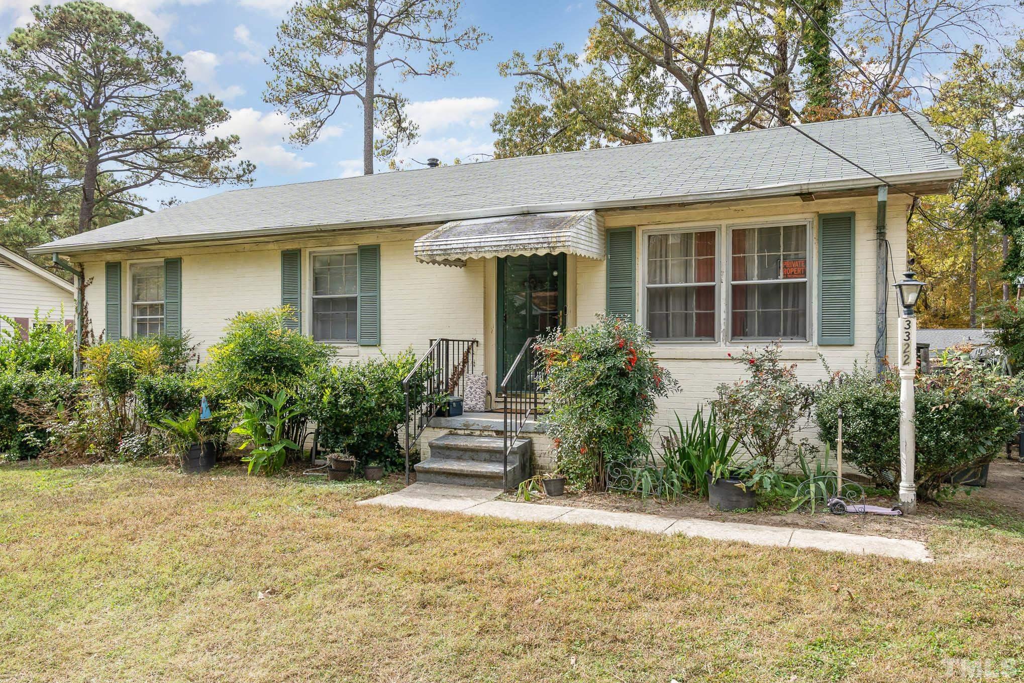 3322 Friar Tuck Road Raleigh, NC 27610 - Photo 3 of 20 a view of a house with potted plants and a large tree